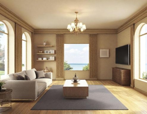 Modern living room with large windows, a sofa, coffee table, and a view of the ocean.